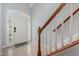 Welcoming foyer with tiled floors, staircase with wooden banister and light-filled glass accent front door at 8004 Thrush Ridge Ln, Raleigh, NC 27615