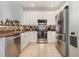 Cozy kitchen featuring stainless steel appliances, white cabinets, and tile flooring at 8004 Thrush Ridge Ln, Raleigh, NC 27615
