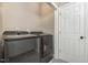 Modern laundry room equipped with sleek washer and dryer units and a convenient utility sink at 8004 Thrush Ridge Ln, Raleigh, NC 27615