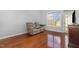 Comfortable living room featuring hardwood floors, a large window, and a plush double recliner at 8004 Thrush Ridge Ln, Raleigh, NC 27615