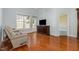 Bright living room with hardwood floors, large window, and a cozy recliner, offering a relaxing atmosphere at 8004 Thrush Ridge Ln, Raleigh, NC 27615