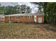 Backyard view of a brick home with a storage shed and mature trees at 813 Burton St, Rocky Mount, NC 27803
