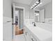 Updated bathroom with white tile, modern fixtures, and doorway leading to another room at 813 Burton St, Rocky Mount, NC 27803