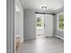 Bedroom with a modern sliding barn door, gray wood-look floors, and natural light at 813 Burton St, Rocky Mount, NC 27803