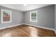 Light and airy bedroom with hardwood flooring and two large windows at 813 Burton St, Rocky Mount, NC 27803