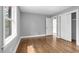 Bright bedroom with hardwood floors, closet, and large window overlooking the property at 813 Burton St, Rocky Mount, NC 27803