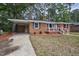 Lovely brick house with attached carport and manicured landscaping at 813 Burton St, Rocky Mount, NC 27803