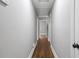Bright hallway with hardwood floors, neutral walls and an access hatch in the ceiling at 813 Burton St, Rocky Mount, NC 27803