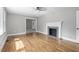 Spacious living room features a decorative fireplace and hardwood flooring at 813 Burton St, Rocky Mount, NC 27803