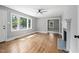 Bright living room with hardwood floors and large windows at 813 Burton St, Rocky Mount, NC 27803