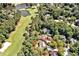 Aerial shot of a house surrounded by lush trees, overlooking a golf course and lake at 84307 Winslow, Chapel Hill, NC 27517