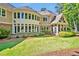 Expansive backyard featuring lush landscaping and ample windows, perfect for entertaining at 84307 Winslow, Chapel Hill, NC 27517