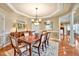 Traditional dining room with chandelier, sideboard, and access to adjacent spaces, making it ideal for hosting gatherings at 84307 Winslow, Chapel Hill, NC 27517