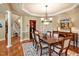 Inviting dining room showcasing stylish wainscoting, chandelier, and an adjacent staircase, creating an elegant space at 84307 Winslow, Chapel Hill, NC 27517