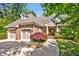 Charming brick home featuring a two-car garage, landscaped front yard, and inviting entrance at 84307 Winslow, Chapel Hill, NC 27517