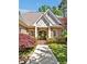 Close up of charming brick home featuring an inviting entrance with beautiful landscaping at 84307 Winslow, Chapel Hill, NC 27517