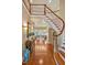 Grand foyer with winding staircase, hardwood floors, and abundant natural light at 84307 Winslow, Chapel Hill, NC 27517