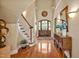 Inviting foyer with hardwood floors, curved staircase, and stylish decor at 84307 Winslow, Chapel Hill, NC 27517