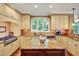 Well-lit kitchen with stainless appliances, custom cabinetry, and a large center island at 84307 Winslow, Chapel Hill, NC 27517