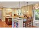 Spacious kitchen featuring a central island, breakfast bar, and stainless steel appliances at 84307 Winslow, Chapel Hill, NC 27517