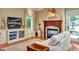 Comfortable living room with a fireplace, built-in entertainment center, and natural light at 84307 Winslow, Chapel Hill, NC 27517
