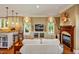 Cozy living room with kitchen bar, a fireplace, built-in cabinets, and views of the backyard at 84307 Winslow, Chapel Hill, NC 27517