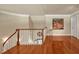 Second floor loft space with hardwood floors and decorative railing at 84307 Winslow, Chapel Hill, NC 27517
