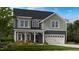Charming two-story home with a covered porch, gray siding, and a two-car garage at 913 Delano Dr, Knightdale, NC 27545