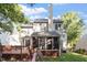 Back exterior of the home features a spacious screened porch, deck, and lush backyard at 9504 Anson Grove Lane Ln, Raleigh, NC 27615