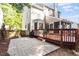View of the back yard with a stone patio and wood deck, perfect for outdoor entertaining at 9504 Anson Grove Lane Ln, Raleigh, NC 27615