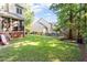 Expansive backyard features a screened porch, lush lawn, and mature trees providing ample shade at 9504 Anson Grove Lane Ln, Raleigh, NC 27615