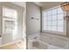 Bright bathroom featuring a bathtub and a glass enclosed shower under a window at 9504 Anson Grove Lane Ln, Raleigh, NC 27615