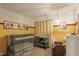 Cozy Bedroom featuring a crib, chair, changing station, and whimsical decor at 9504 Anson Grove Lane Ln, Raleigh, NC 27615
