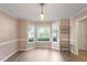 Bright dining room with large windows, hardwood floors, and modern lighting fixtures at 9504 Anson Grove Lane Ln, Raleigh, NC 27615