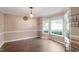 Formal dining room with hardwood floors, neutral walls, crown molding, and bright windows at 9504 Anson Grove Lane Ln, Raleigh, NC 27615