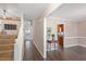 Bright foyer with hardwood floors, staircase, and a glimpse into the living spaces at 9504 Anson Grove Lane Ln, Raleigh, NC 27615