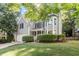 Attractive two-story gray home with well-maintained front lawn, featuring a classic design and attached garage at 9504 Anson Grove Lane Ln, Raleigh, NC 27615