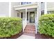 Inviting front porch with brick steps, complemented by manicured bushes and the house number at 9504 Anson Grove Lane Ln, Raleigh, NC 27615