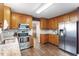 Well-equipped kitchen with stainless steel appliances, granite countertops, and wooden cabinetry at 9504 Anson Grove Lane Ln, Raleigh, NC 27615