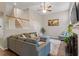Spacious living room with high ceilings, ceiling fan, fireplace, and a comfortable sectional sofa at 9504 Anson Grove Lane Ln, Raleigh, NC 27615