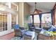 Inviting screened porch with wicker furniture, blue cushions, and a ceiling fan for relaxing outdoors at 9504 Anson Grove Lane Ln, Raleigh, NC 27615