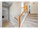 A home staircase with gray carpet, white risers, and light wood handrail at 9504 Anson Grove Lane Ln, Raleigh, NC 27615