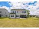 Large, grassy backyard with a view of the home's rear exterior and patio at 1051 Jura Ridge Dr, Fuquay Varina, NC 27526