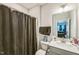 Neutral toned bathroom features a shower with a dark curtain, toilet, and vanity with sink at 1051 Jura Ridge Dr, Fuquay Varina, NC 27526