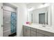 Bright bathroom showcasing double sink vanity, a large mirror and shower with blue curtain at 1051 Jura Ridge Dr, Fuquay Varina, NC 27526