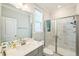 Bright bathroom featuring a walk-in shower, marble tile, and a modern vanity with sink at 1051 Jura Ridge Dr, Fuquay Varina, NC 27526