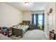 This bedroom features a window with blue curtains, toys, and a bed at 1051 Jura Ridge Dr, Fuquay Varina, NC 27526