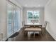 This dining room features wood flooring, a table, and a sliding glass door at 1051 Jura Ridge Dr, Fuquay Varina, NC 27526