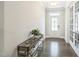 Bright foyer with hardwood floors, stylish console table, and french doors leading to other rooms at 1051 Jura Ridge Dr, Fuquay Varina, NC 27526