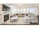 Cozy living room featuring a fireplace, large sectional sofa, and plenty of natural light at 1051 Jura Ridge Dr, Fuquay Varina, NC 27526